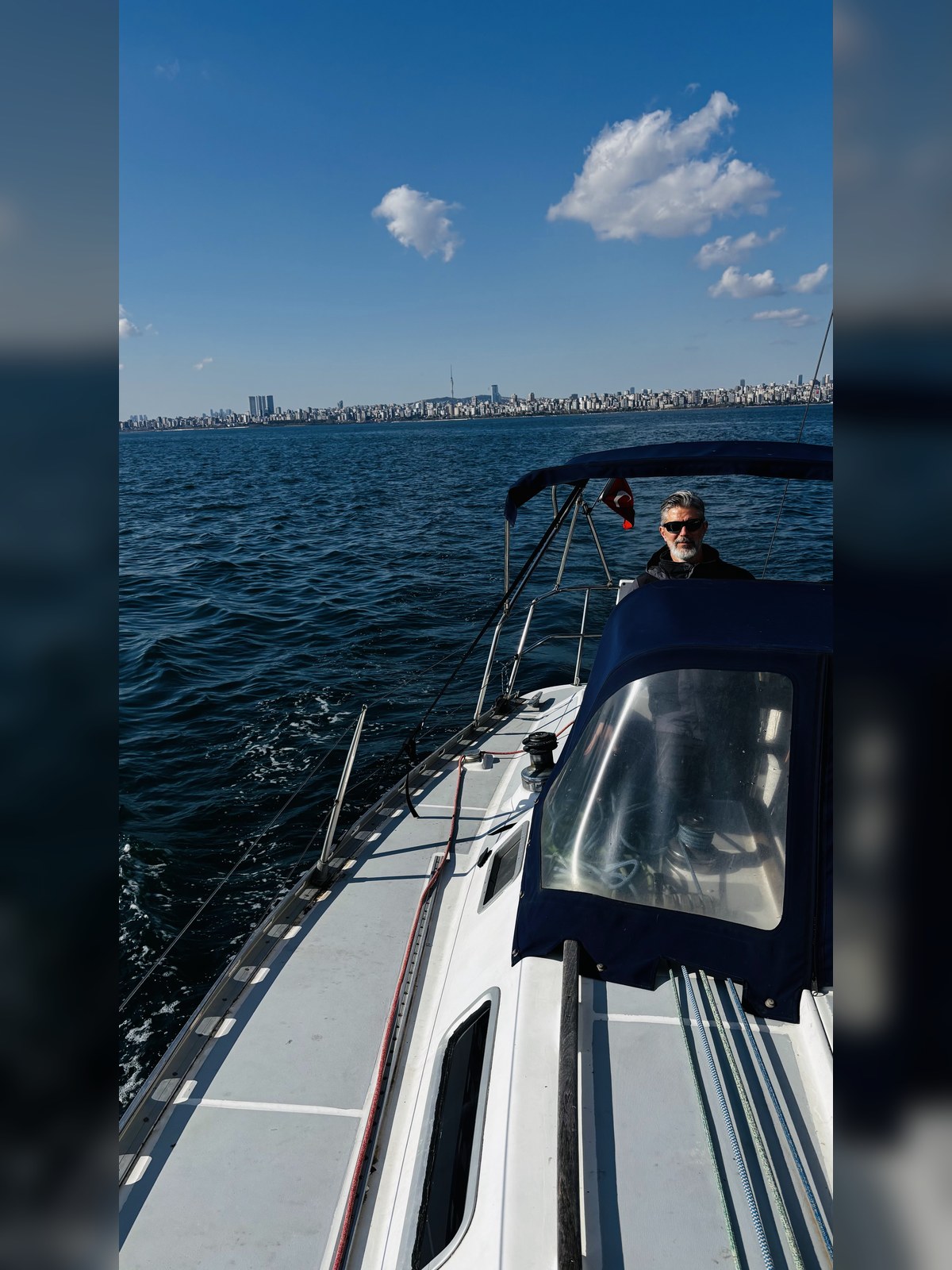 Tekne güvertesinde eğitmen ve İstanbul kıyısı